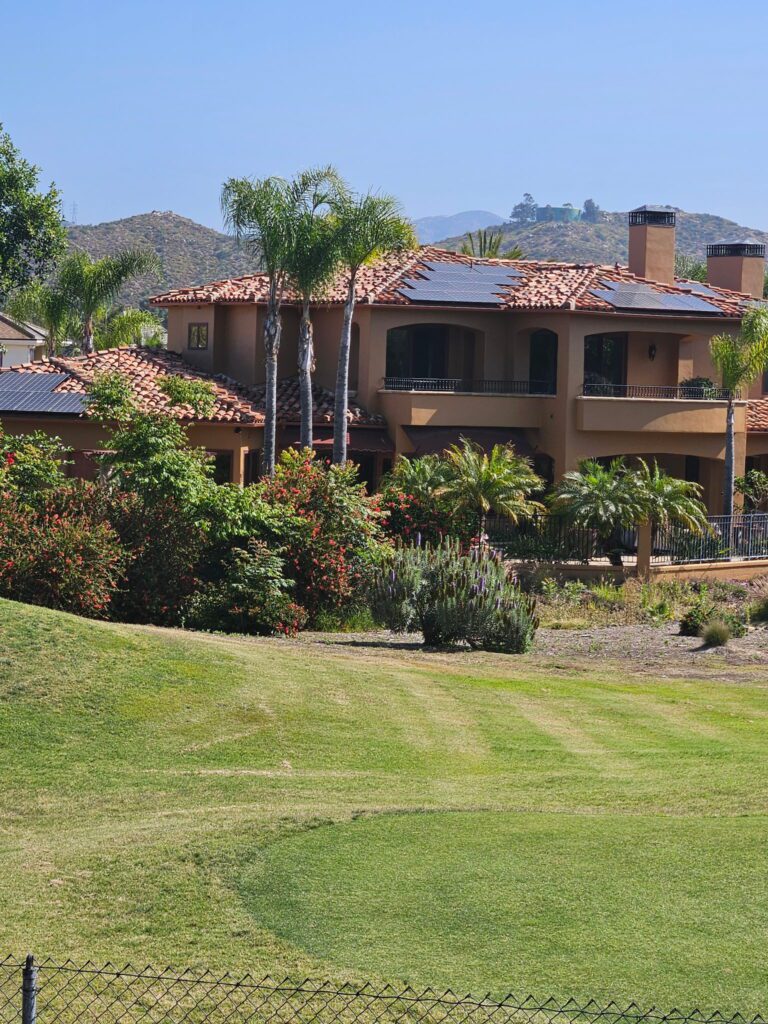 A large house with a lush green lawn in front of it.