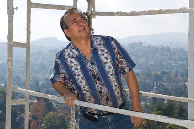 A man standing on top of a metal structure.