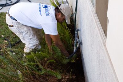 A man in white shirt working on wall.