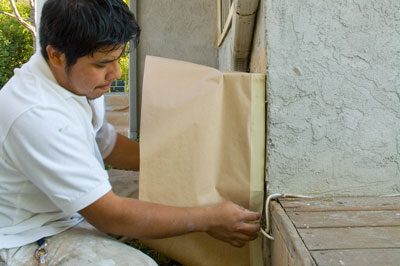 A man is holding onto some brown paper bags
