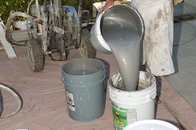 A bucket of cement and a plastic container